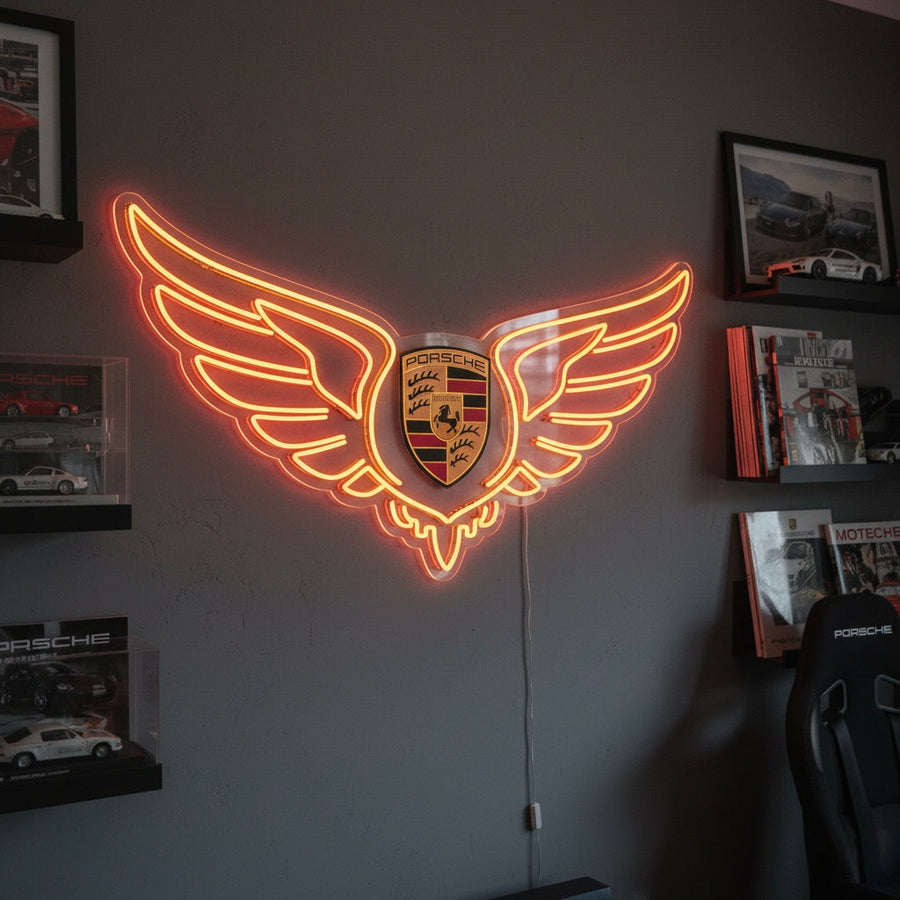 Neon sign featuring Porsche crest with large glowing wings in orange, perfect for automotive enthusiasts.